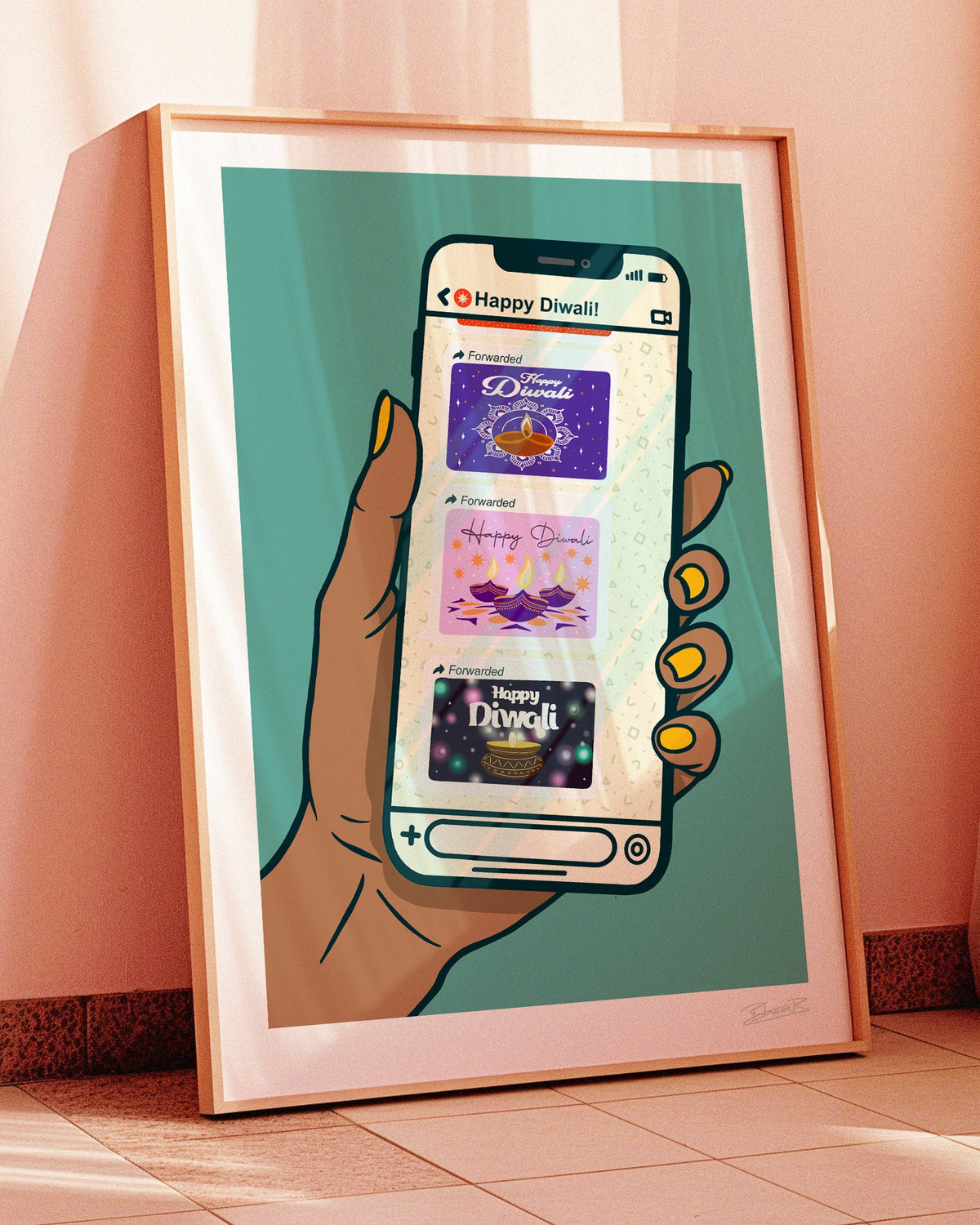 A framed art print leaning against a pink wall on a tiled floor, showing a stylized hand holding a smartphone with Diwali-themed app screens and the text 'Happy Diwali'.